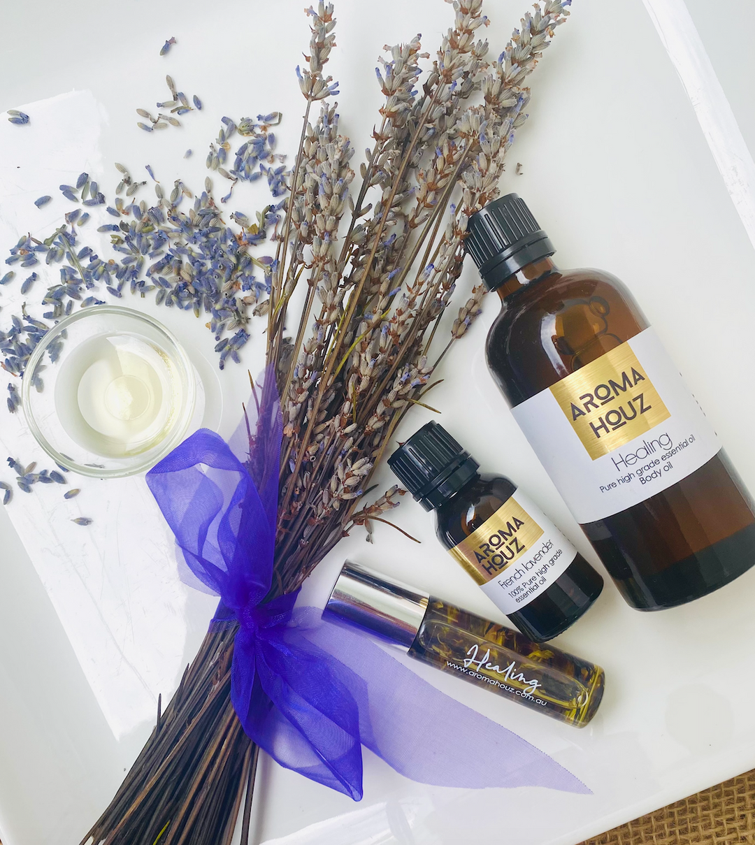 Aroma therapy oils with dried lavender on a white background