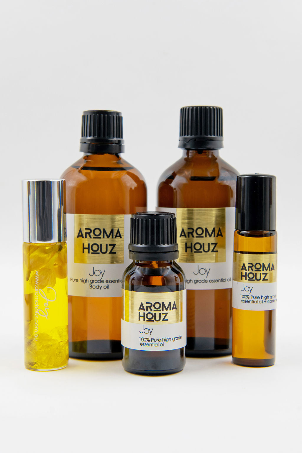 Assortment of Aroma Houz essential oil bottles in various sizes against a white background