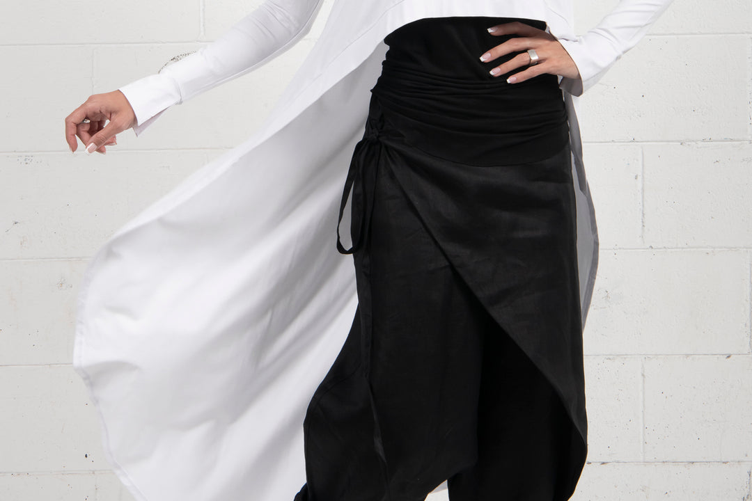 Detail of a black and white draped garment highlighting elegant fabric contrast