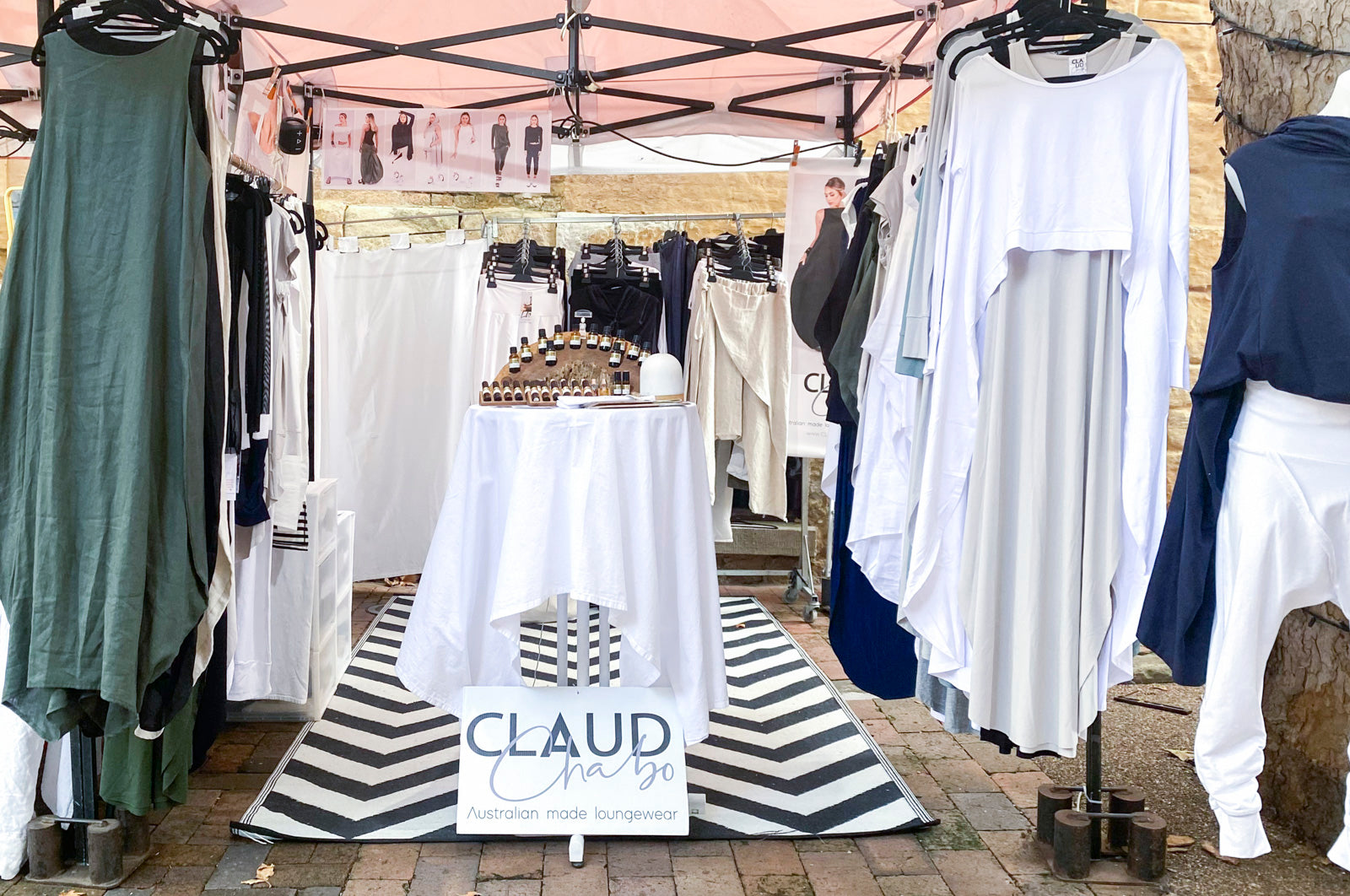 Claud Chabo market stall displaying a variety of garments under a tent